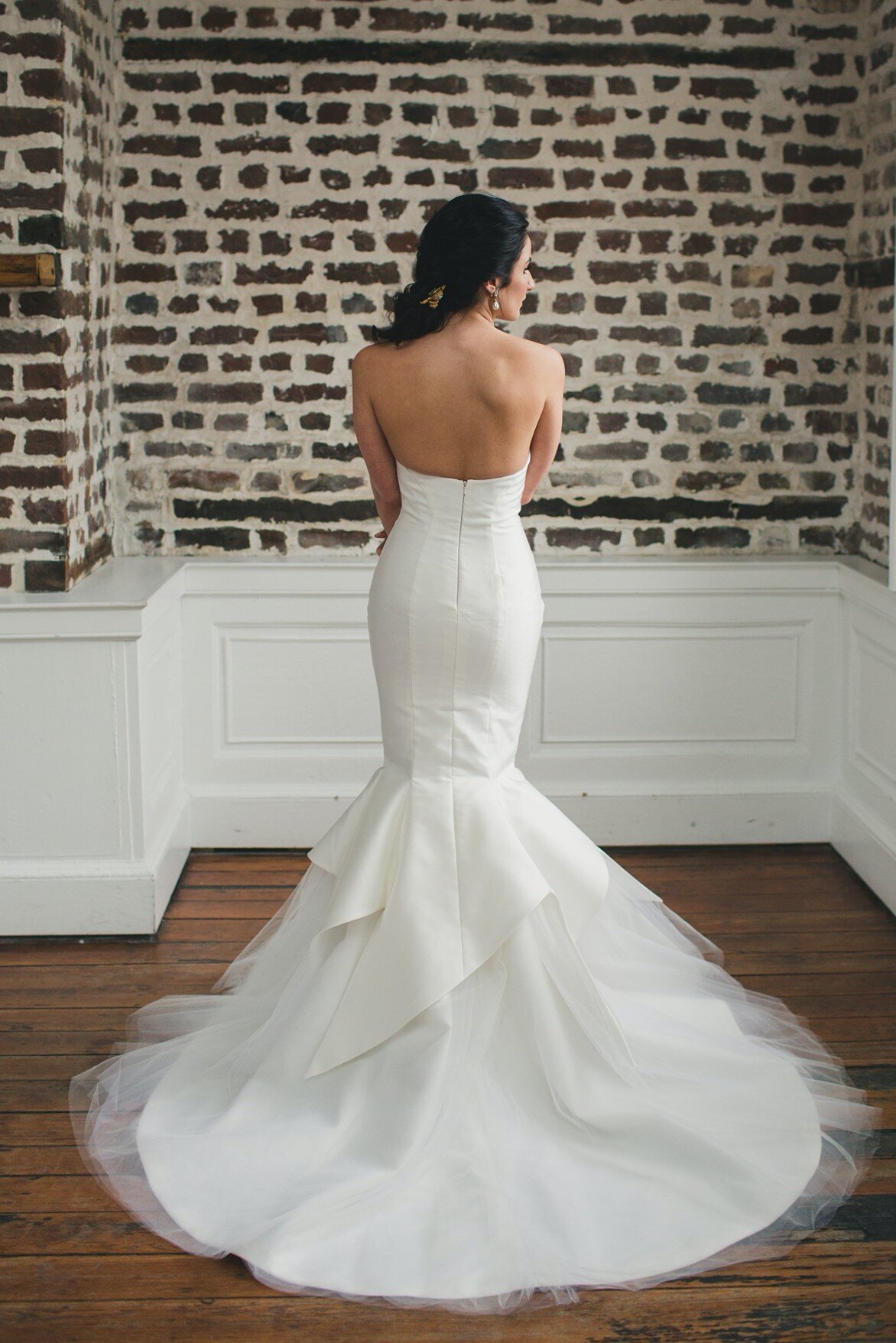 The back of the Amaryllis wedding dress reveals the unique and asymmetric details of the petal shapes that overlap onto the tulle mermaid skirt.