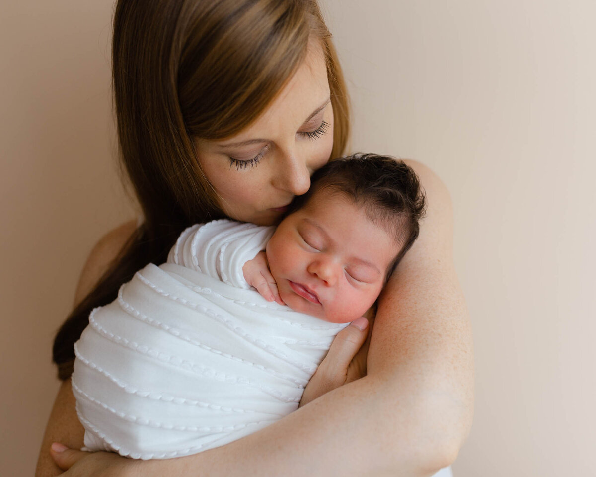 newborn baby in mom arms