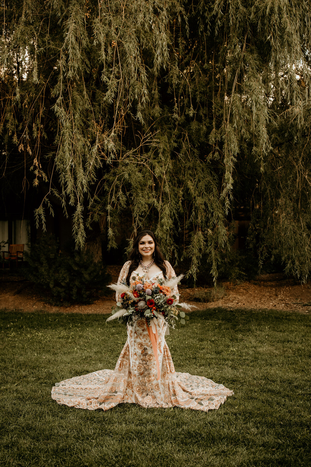 bride standing in her peach lace wedding dress
