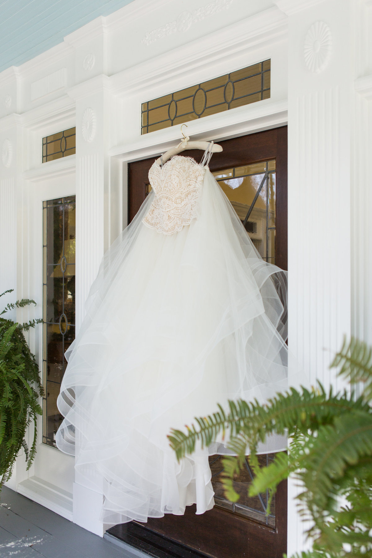 wedding dress hanging on door of mackey house