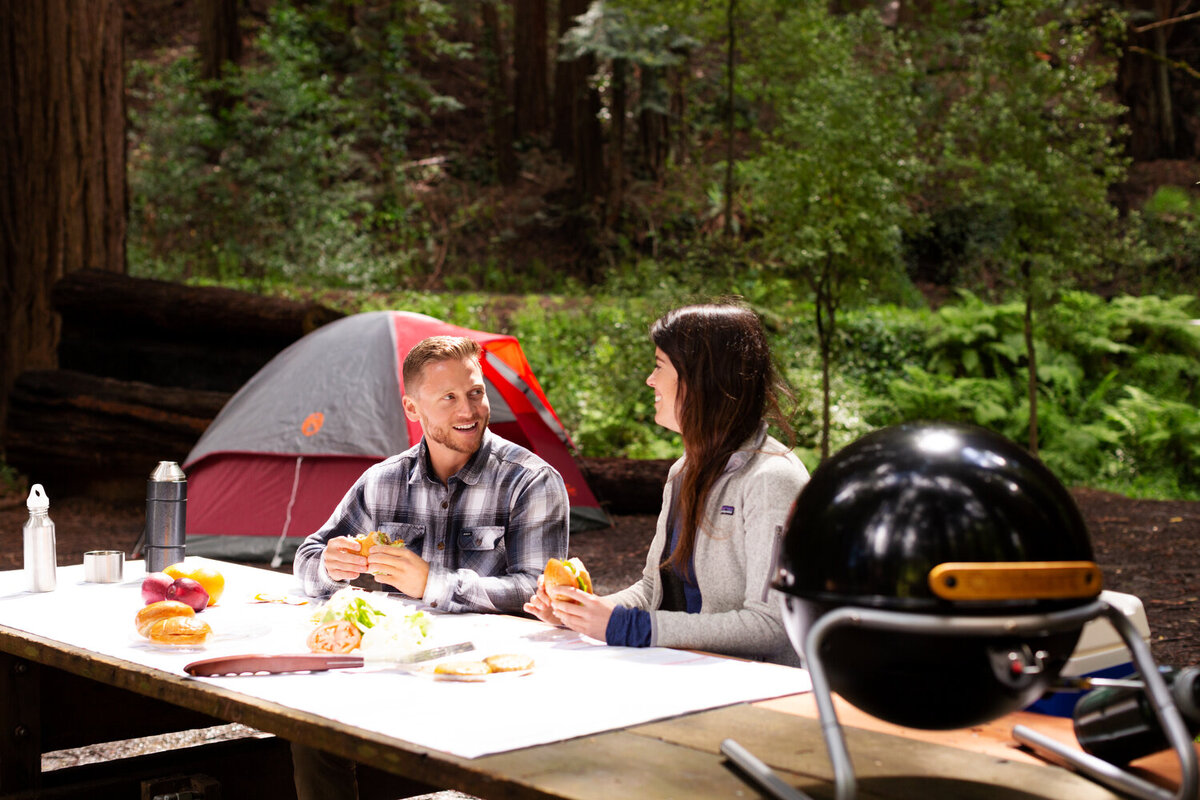 Greer Rivera Commercial Photography Marin CA People camping and eating dinner at  a table with cuisinart grill