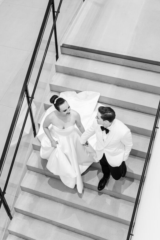 bride and groom walking down stairs at their Museum of Contemporary Art San Diego wedding