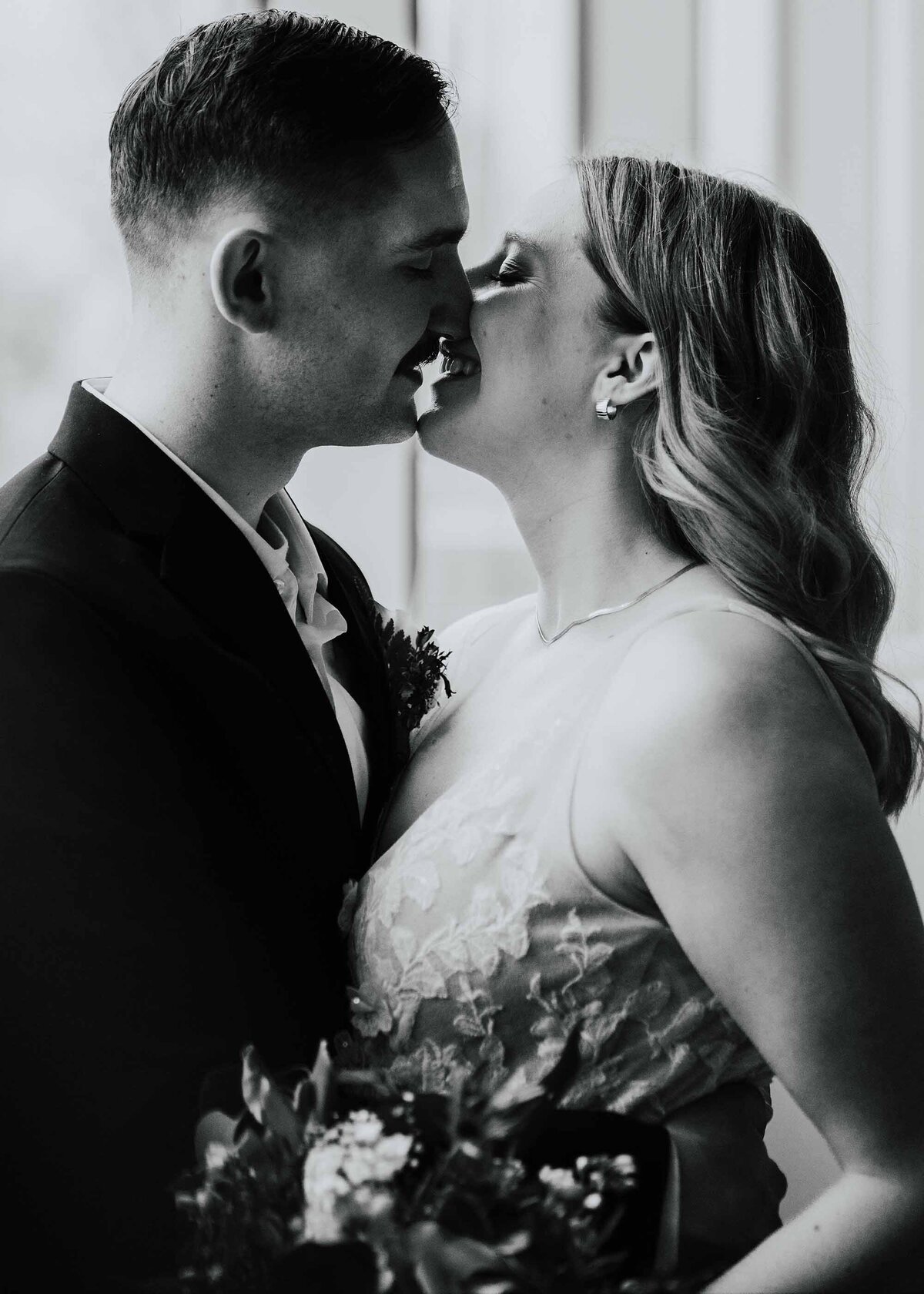 Maddie Rae Photography black and white of the bride and groom kissing