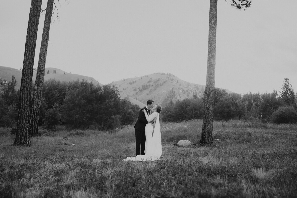 bride and groom kiss surrounded by the Montana mountains