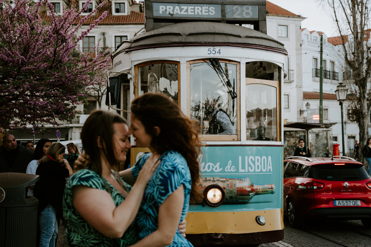 Couple standing close to tram in Lisbon Portugal