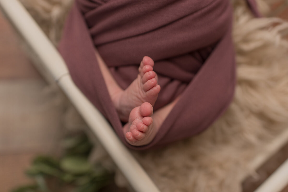 Baby feet, baby wrapped in pink wrap
