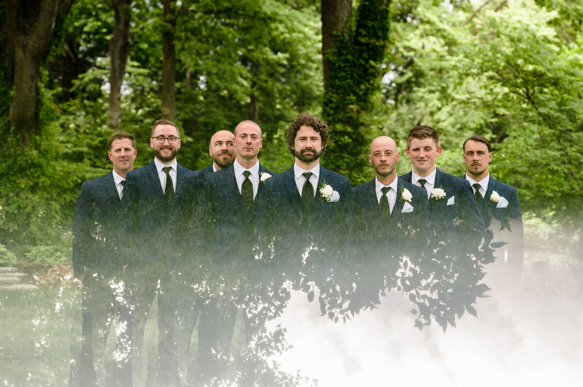 Groomsmen reflected with the trees