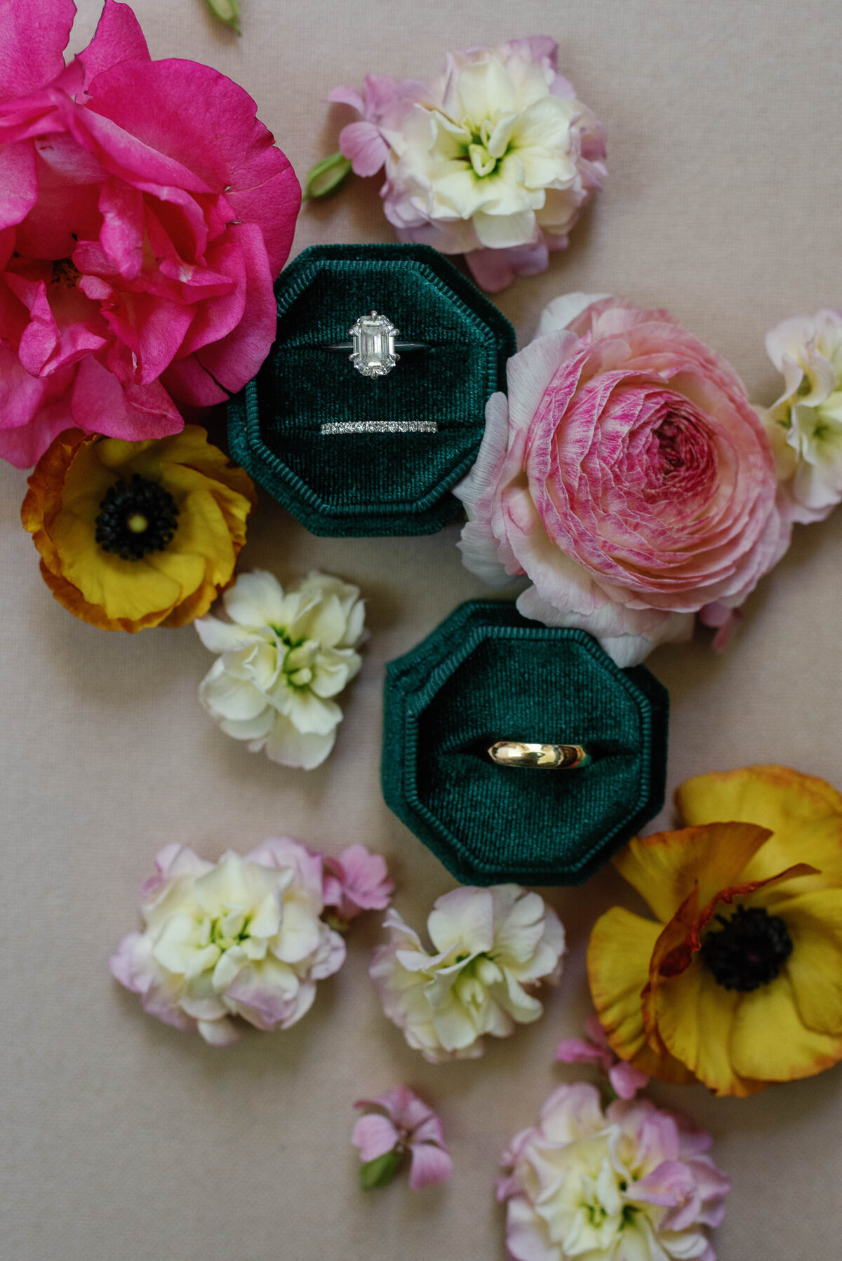 vrai wedding rings surrounded by nectar and root florals with peach, rananculous and local flowers