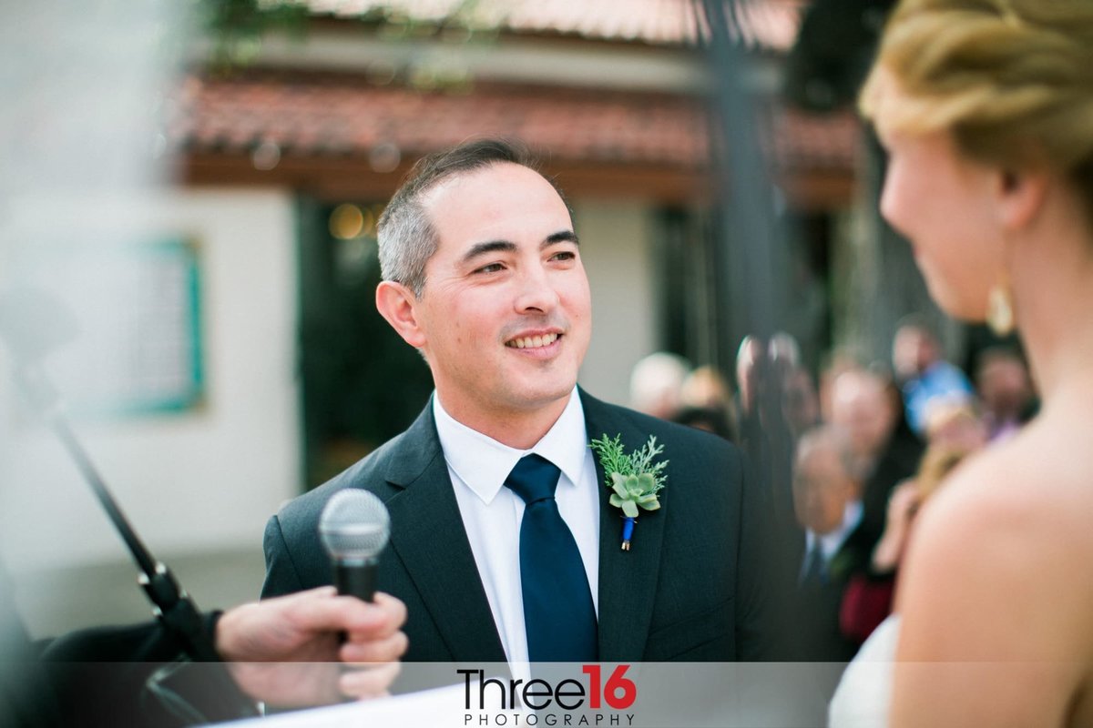 Groom smiles at his Bride during the wedding vows