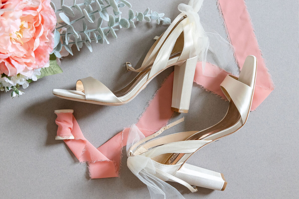 wedding shoes with peach ribbon and flowers detail by wedding photographer in Texas