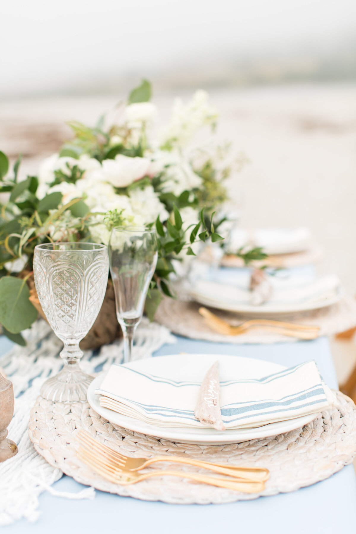 Maine coastal table scape with driftwood and greenery