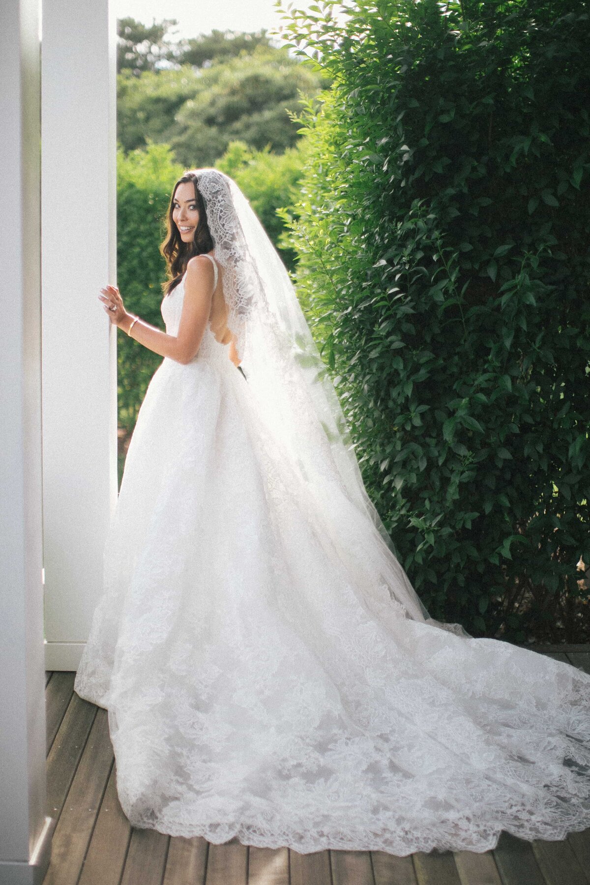 Bride Smiling with Lace Wedding Gown and Veil