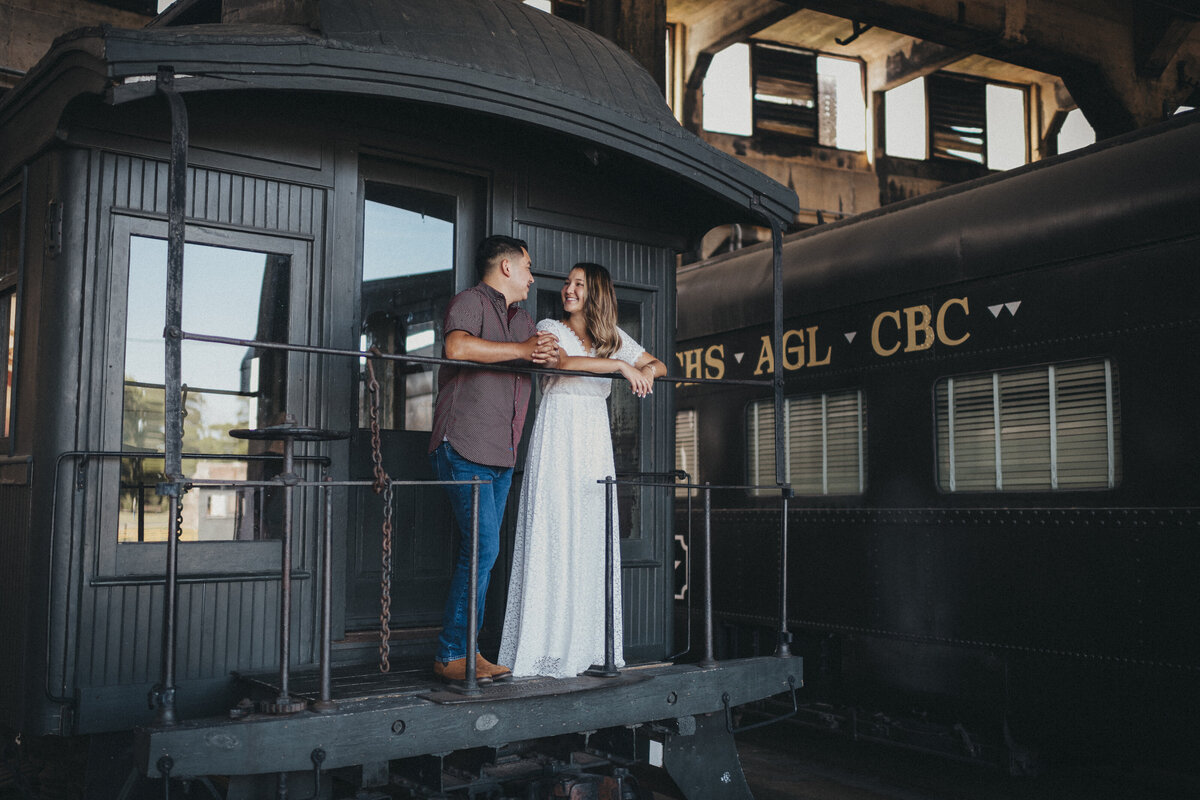 Couple on a train at the georgia rail road museum engagement shoot