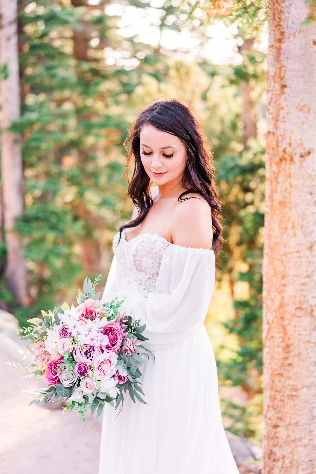 bride looking down at bouquet in national park in colorado