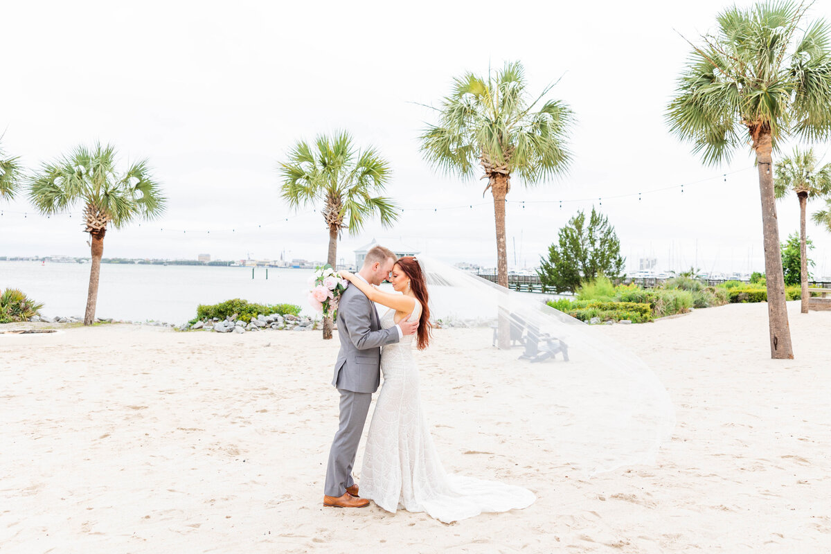 bride and groom embracing on the beach in south carolina