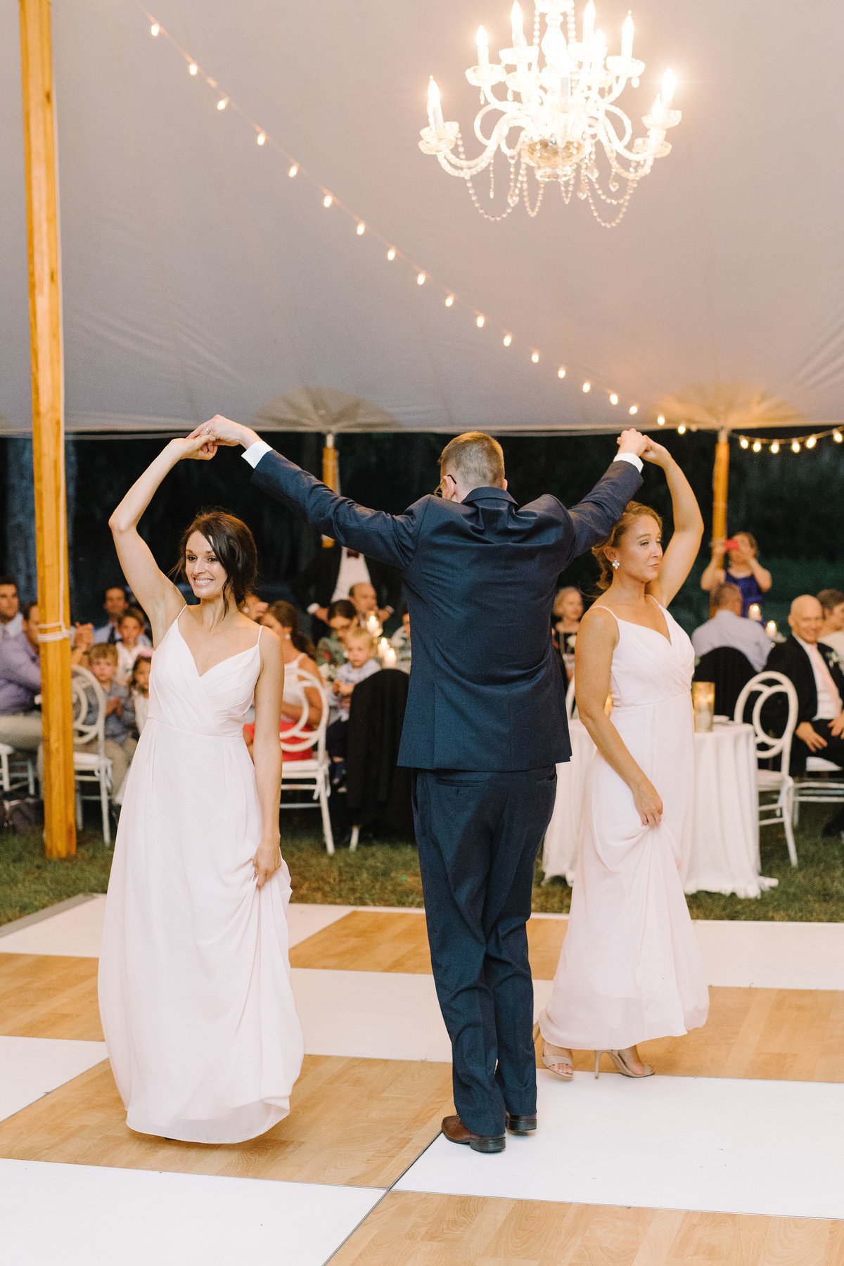 Wedding Party on Birch Wood and White checkered Dance Floor under Sailcloth Tent with Cafe Lighting and Crystal Chandeliers