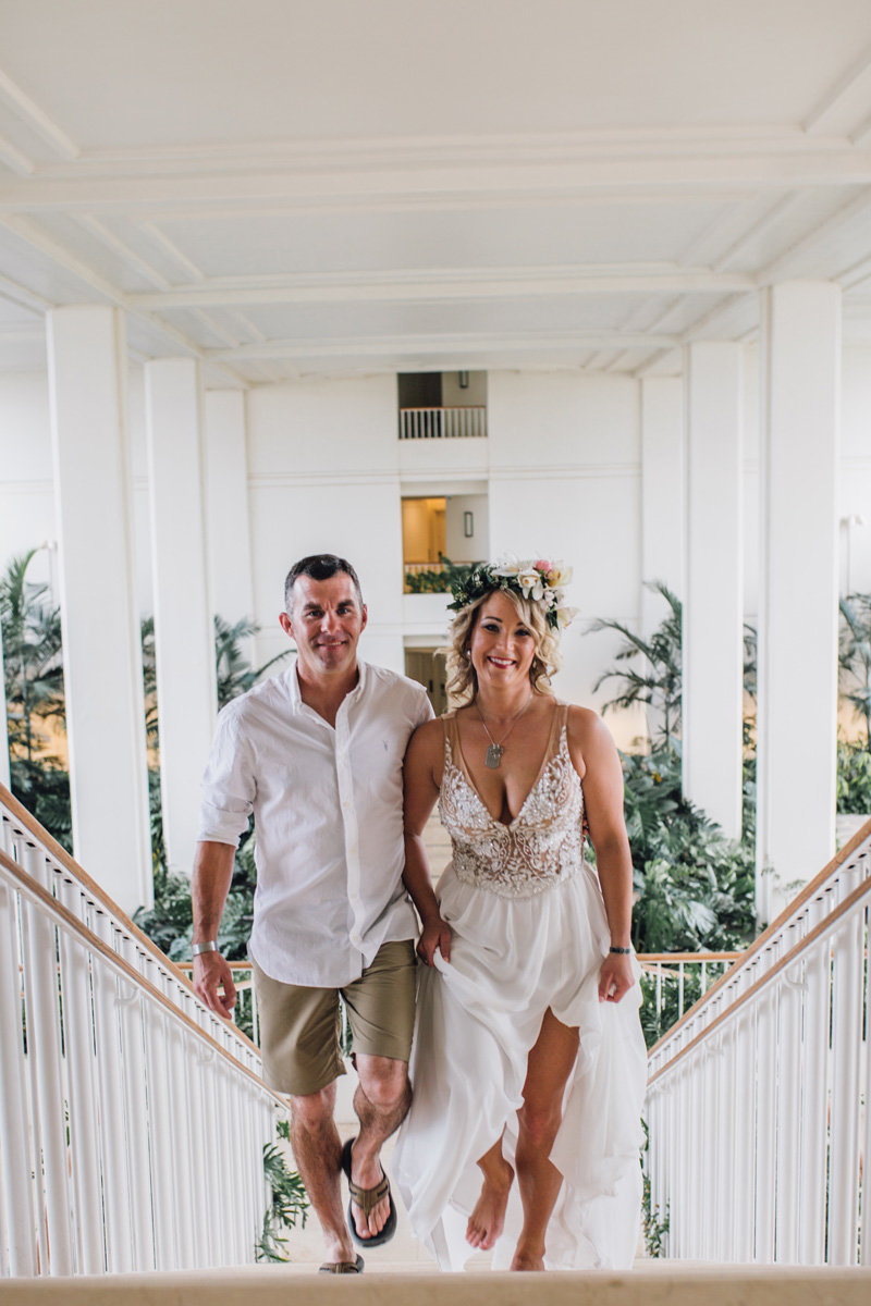 Silber Medal of Honor recipient and his bride walking up the stairs after their first look at the Four Seasons Oahu