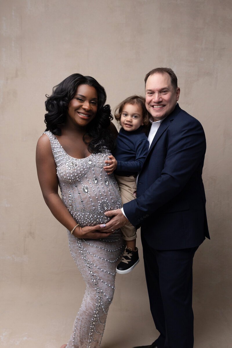 Parents holding a child and framing baby bump, taken by new jersey maternity photographer Ally Kimpton Photography