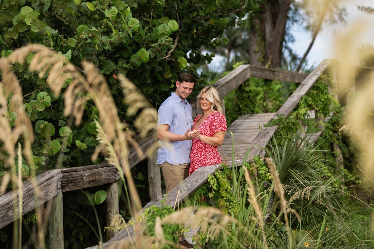 Newly engaged couple at Bean Point boardwalk by Love and Style Photography