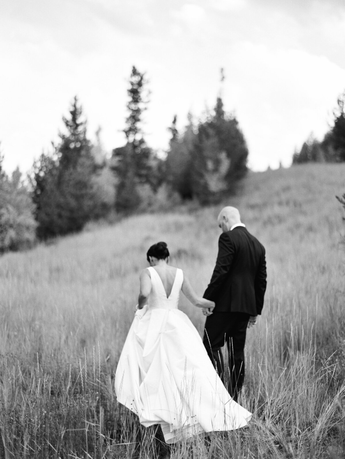 Couple walking during sunset at Brush Creek Ranch wedding