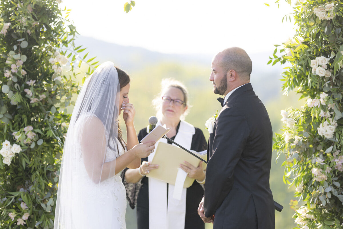 bride and groom sharing vows during ceremony - candlelight farms inn wedding