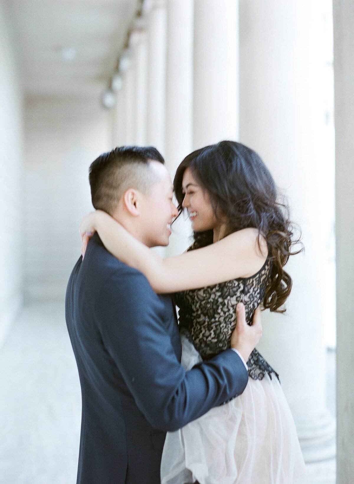 A freshly engaged couple pose for engagement photographer Robin Jolin in the Palace of Fine Arts, San Francisco.