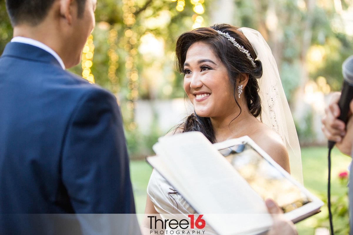 Stunning Bride smiles at her Groom during wedding ceremony