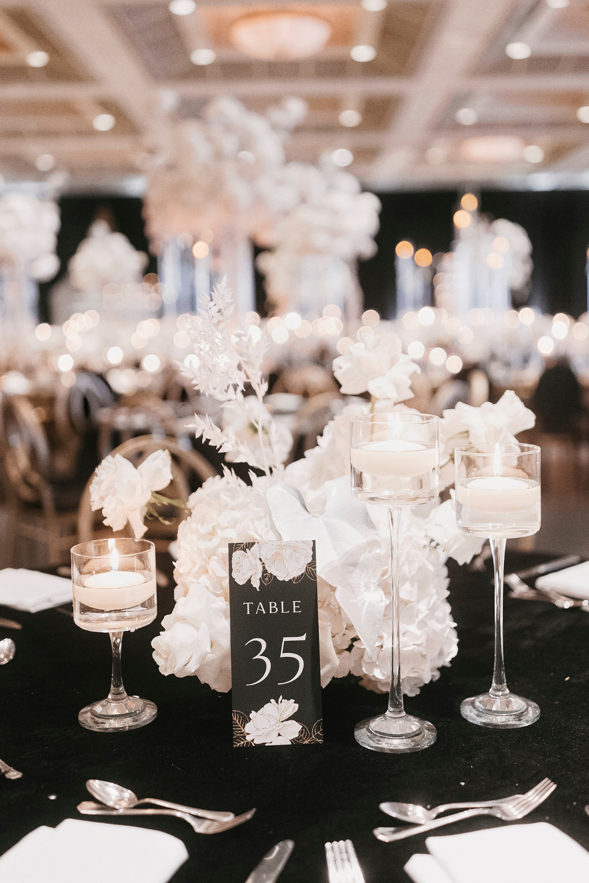 kavita-mohan-black-white-reception-candles-flowers-hydrangea-stationery-table-number