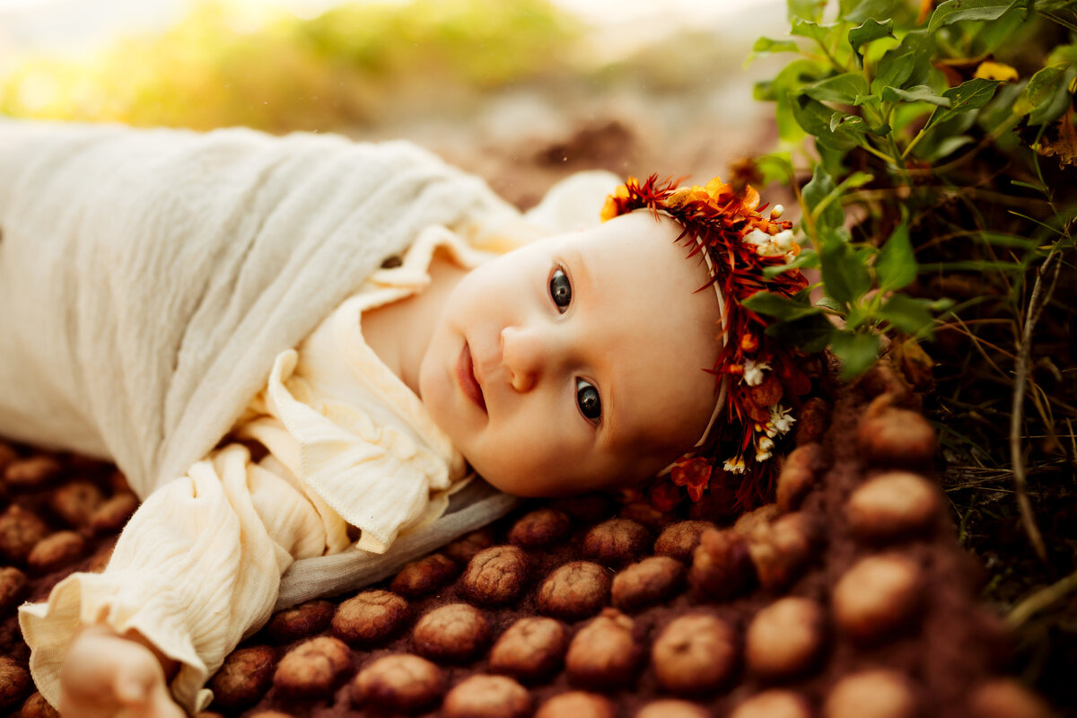 colorful vintage vibed boho baby portrait outside at the beach