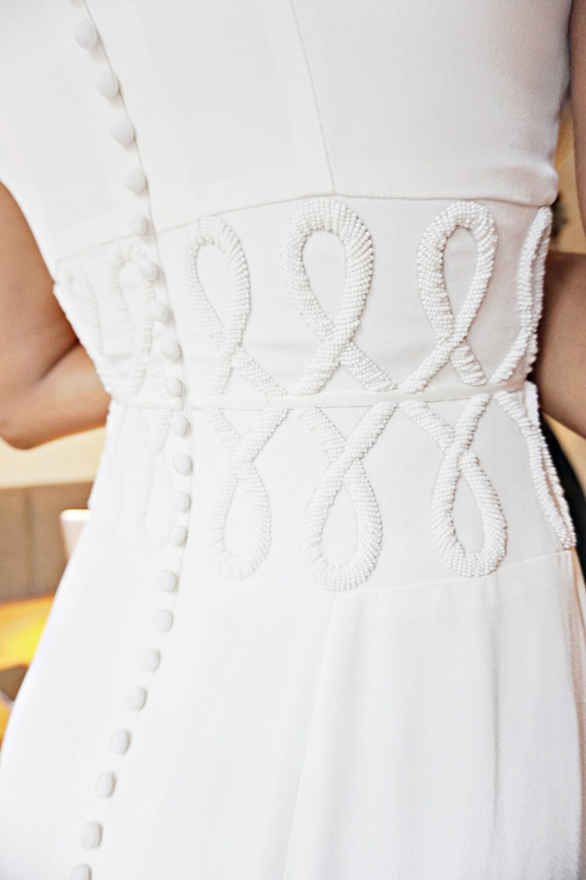 The waistline of the Anila style is hand-beaded with a subtle 3D geometric motif that wraps around the waist.