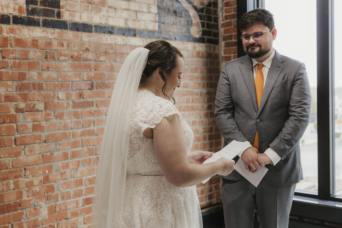 bride reading a note to a groom