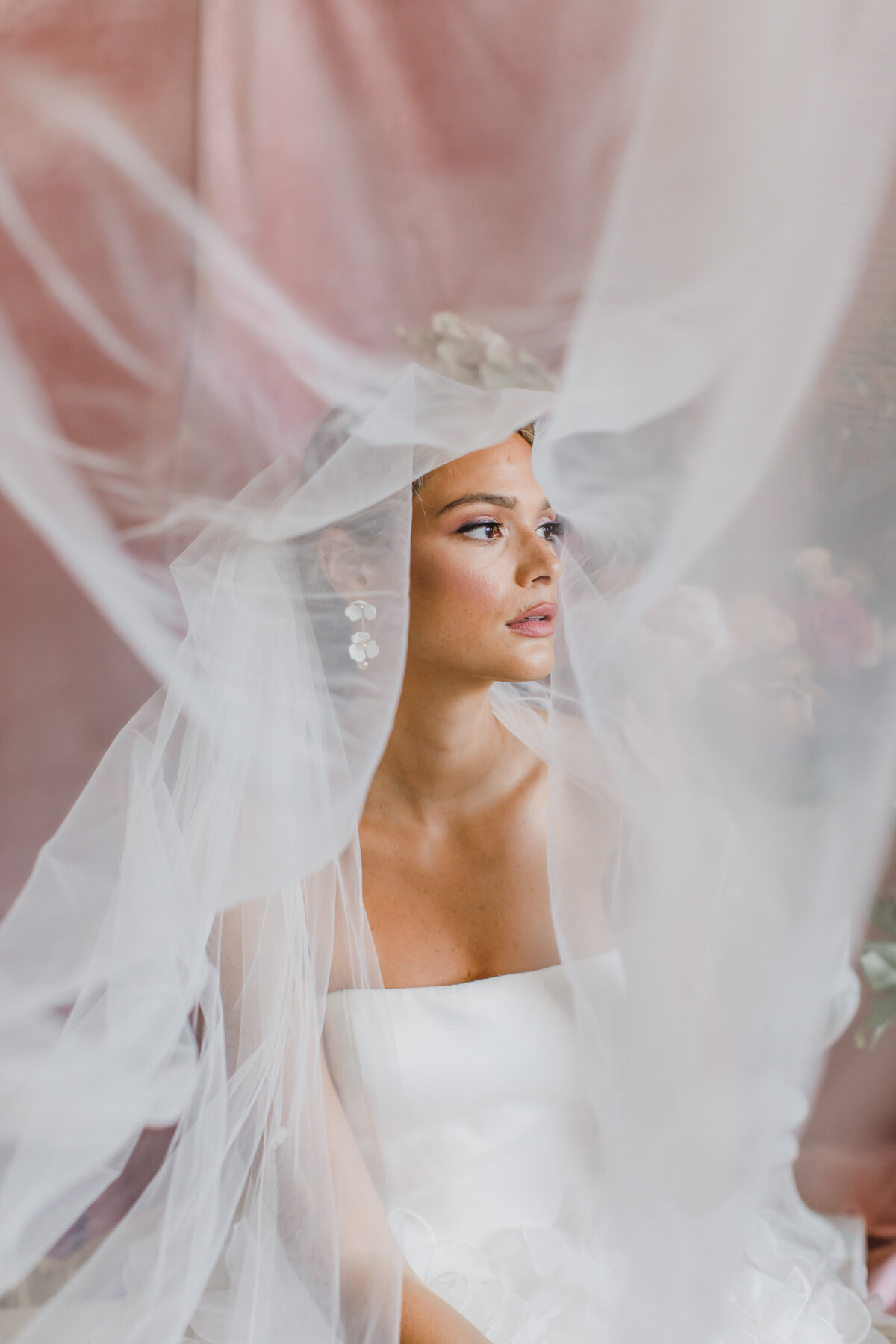 Wedding Photographer & Elopement Photographer Bride looks out from timeless veil