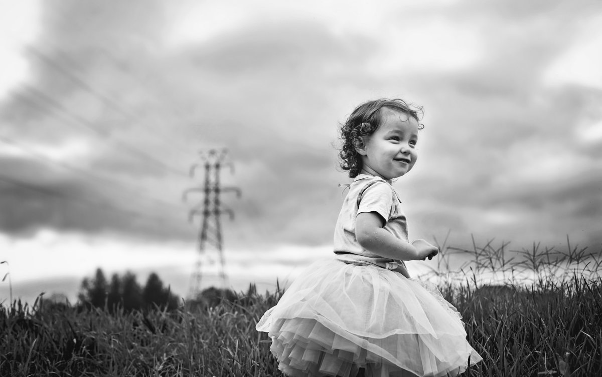 charlotte documentary photographer captures a day in the life with small child playing outdoors before a storm rolls in