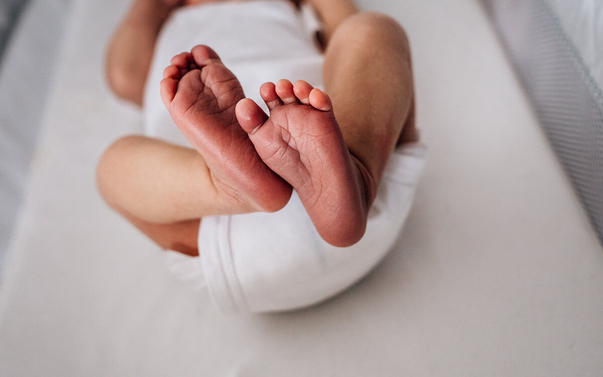 A close up image of a newborn baby's feet, shot by newborn photographer Kate Simpson, in Minneapolis.