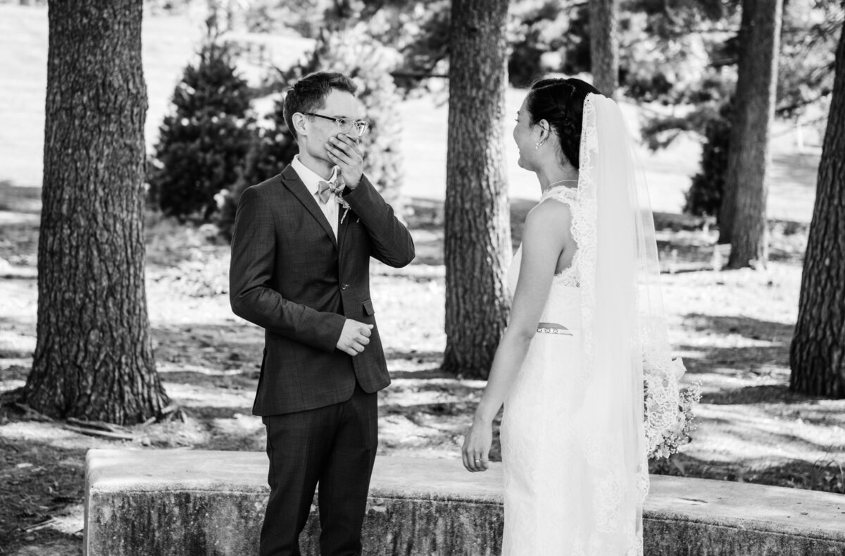 black and white photos during first look with bride and groom
