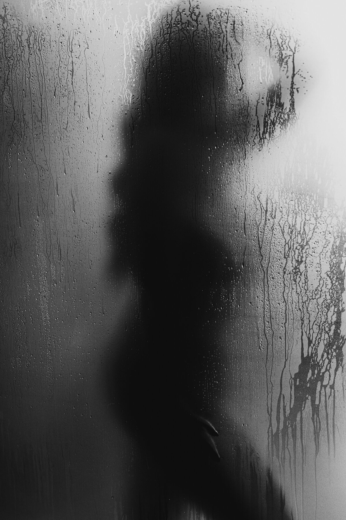 plus size woman silhouette behind a shower door
