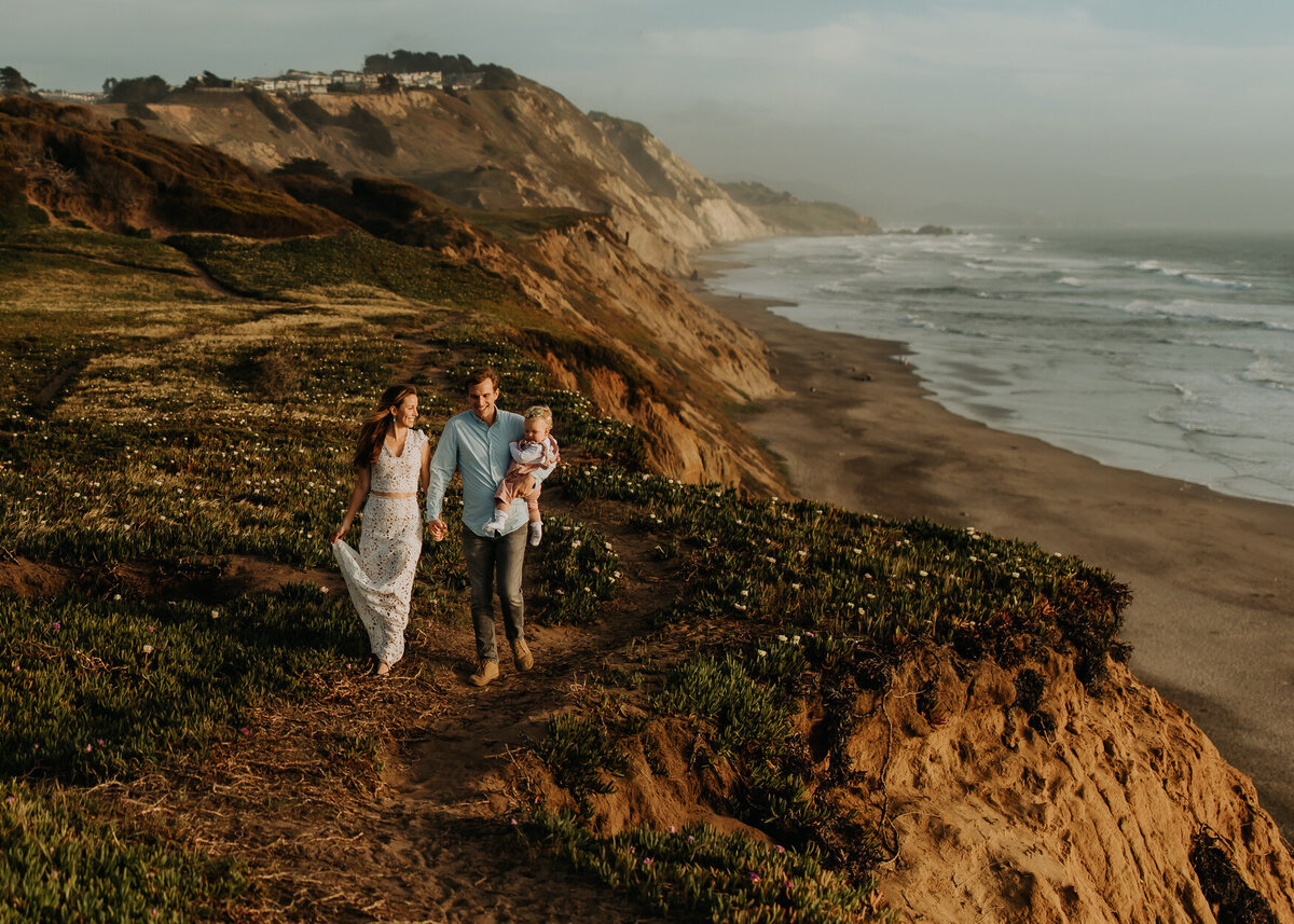 Lifestyle family picture walking on California bluffs  looking toward the Pacific ocean