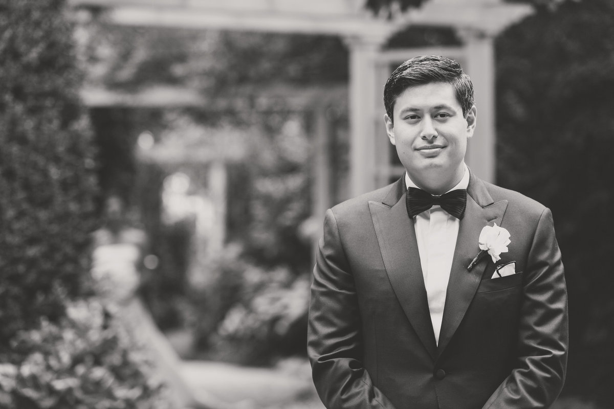 black and white solo shot of groom from wedding reception at The Garden City Hotel