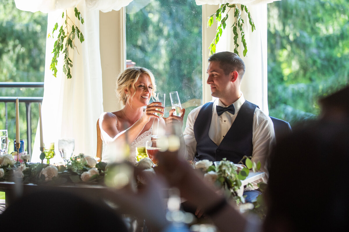 image of bride and groom toasting glasses