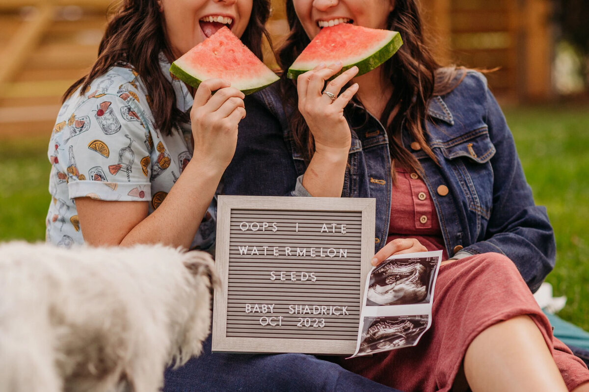 photo of letter board and. couple eating watermelon