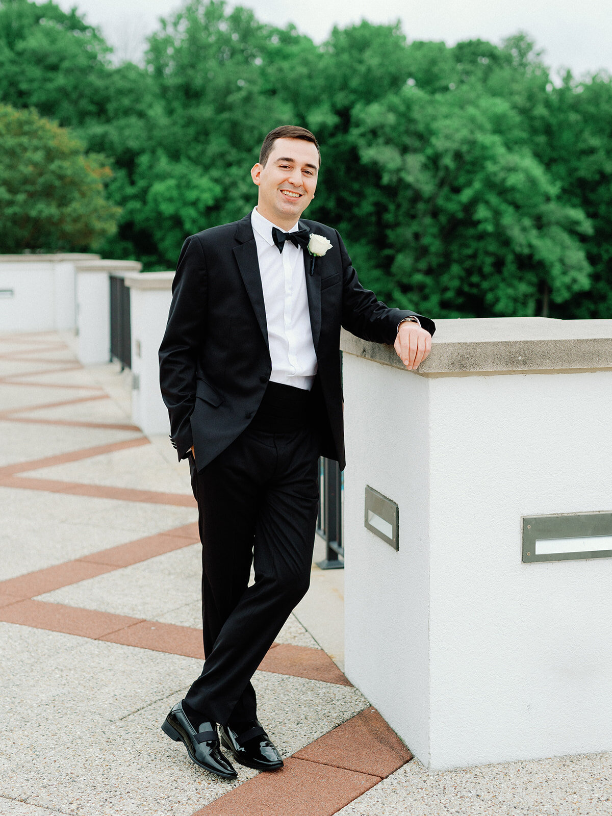 Groom poses for portraits at congressional country club