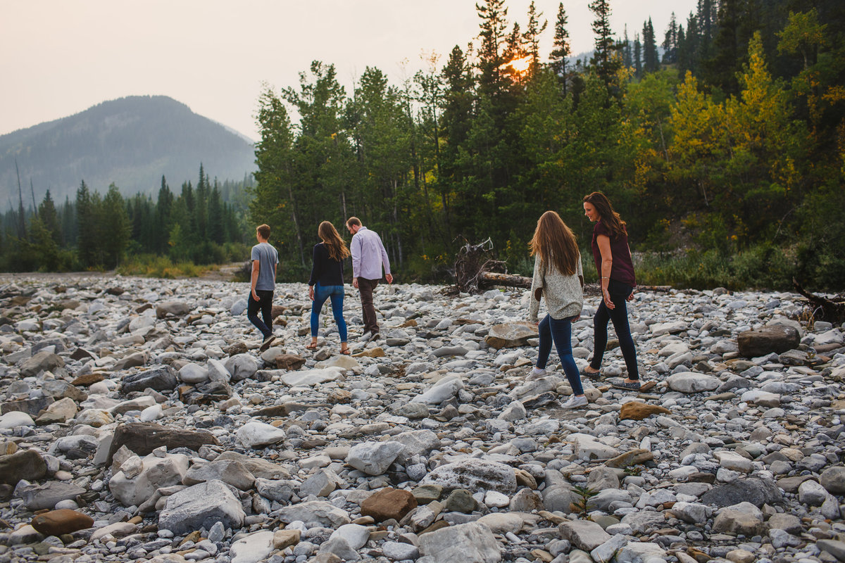family walking on rocks in the Rockies