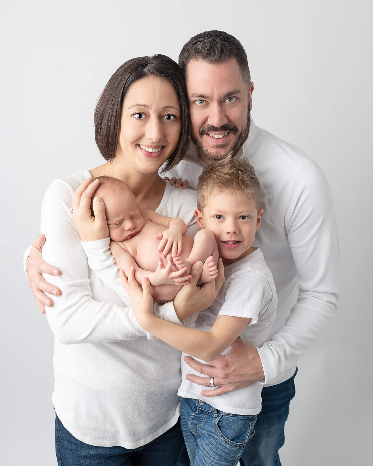 Family Portrait with newborn and toddler boy, simple all white studio