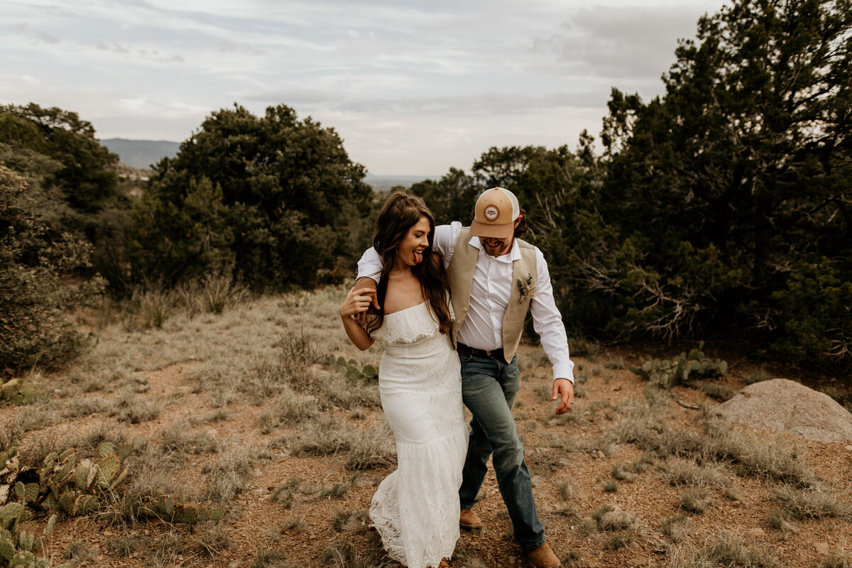 newlyweds walking through the foothills in Albuquerque New Mexico