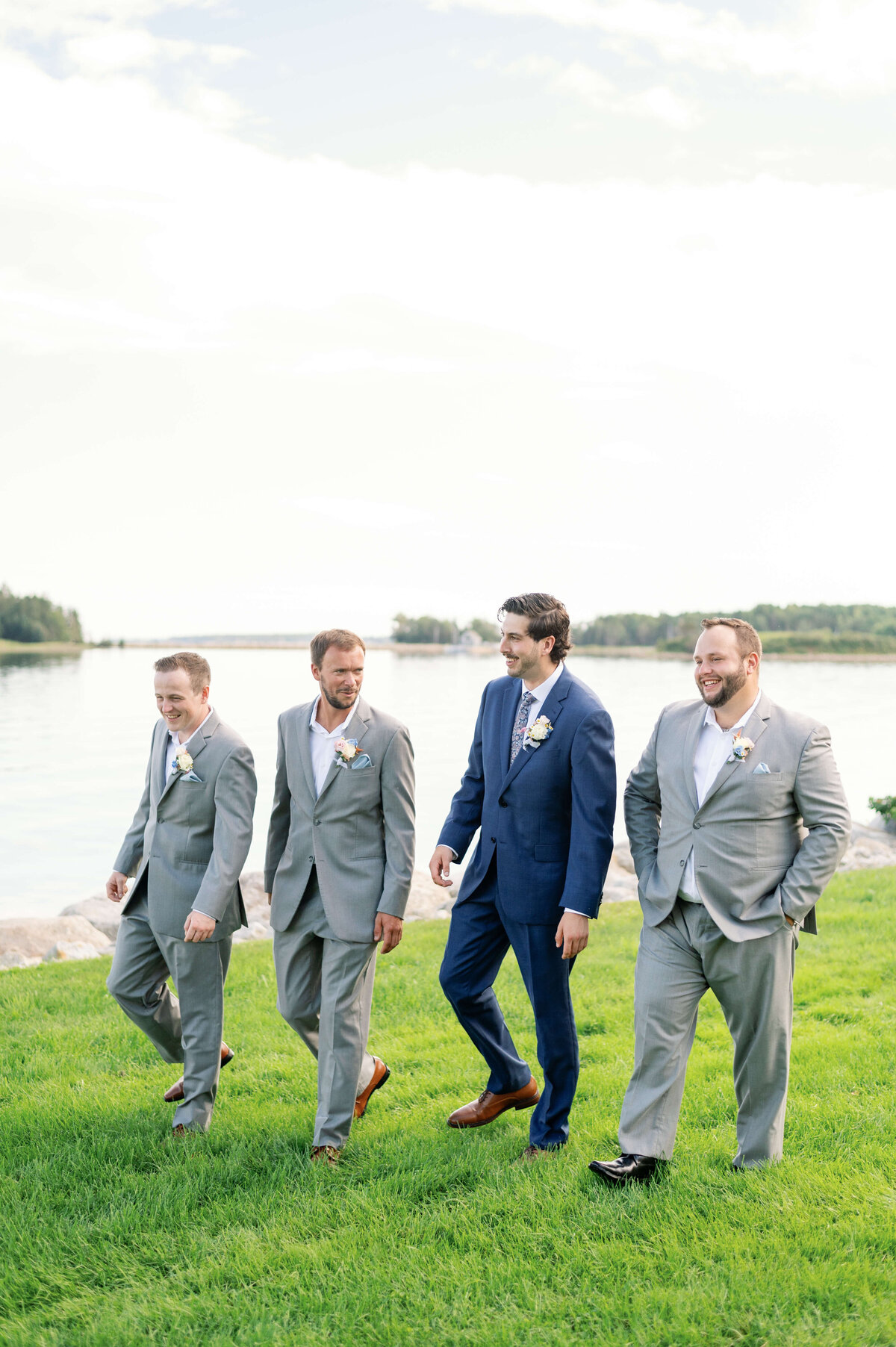 Groom walking along with groomsmen at Oak Island Resort, Nova Scotia