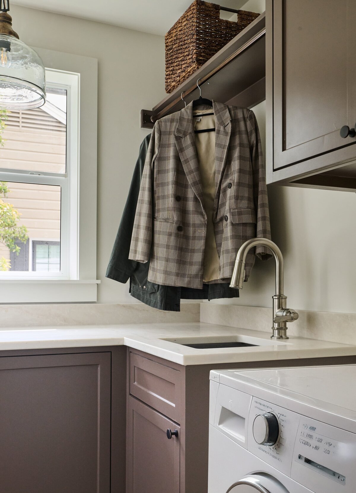 cocoloba homes graham laundry room with small sink and white washer