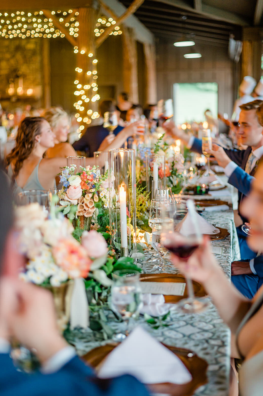 Wedding guests clink glasses during toasts