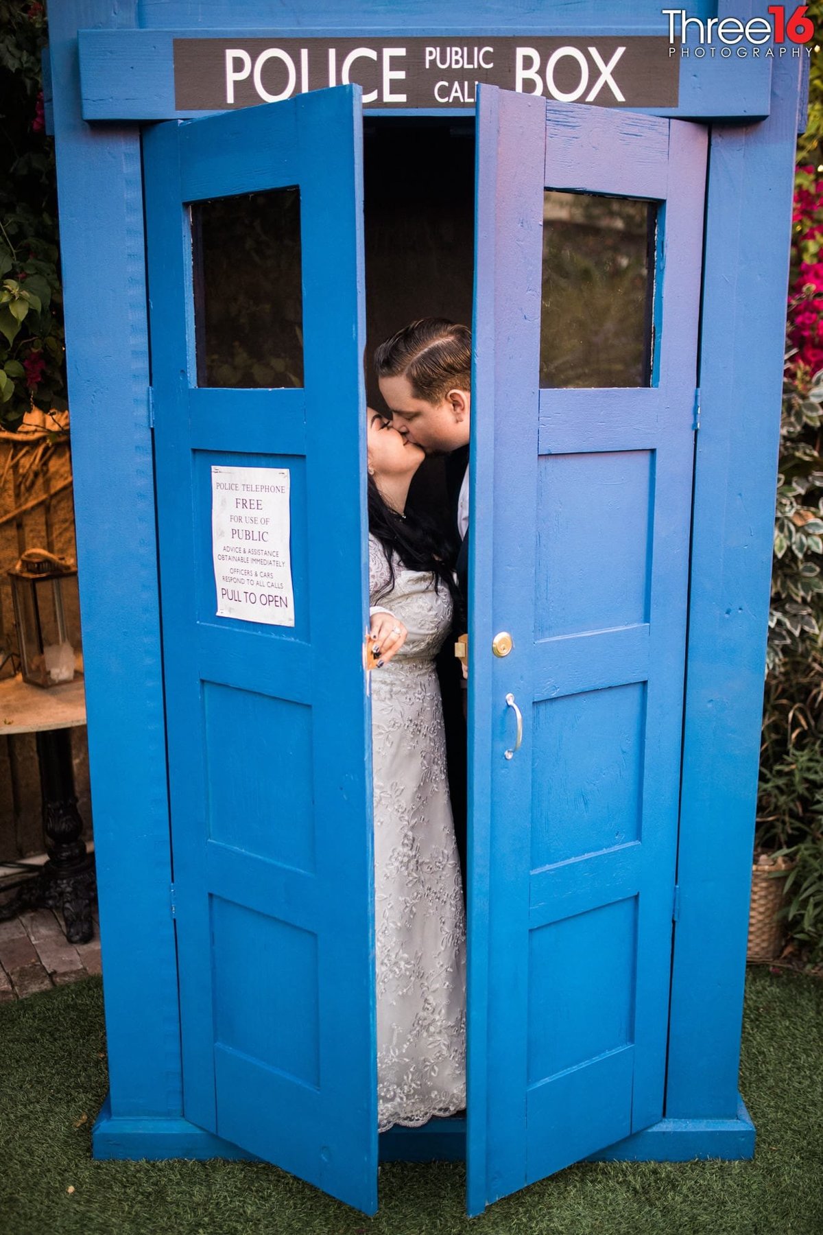 Husband and Wife kiss inside the public police box
