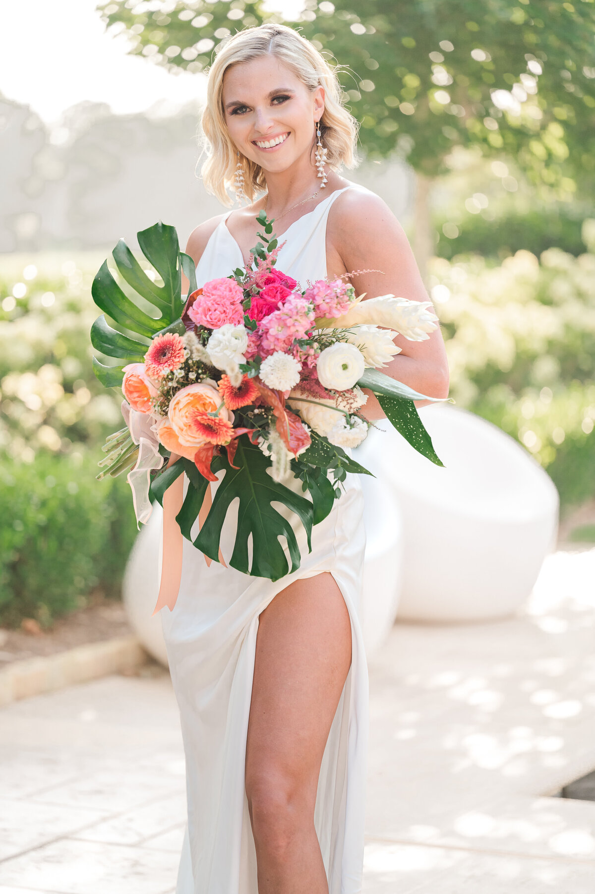A smiling blonde bride on her wedding day in Charlotte enjoying her North Carolina wedding photos by JoLynn Photography