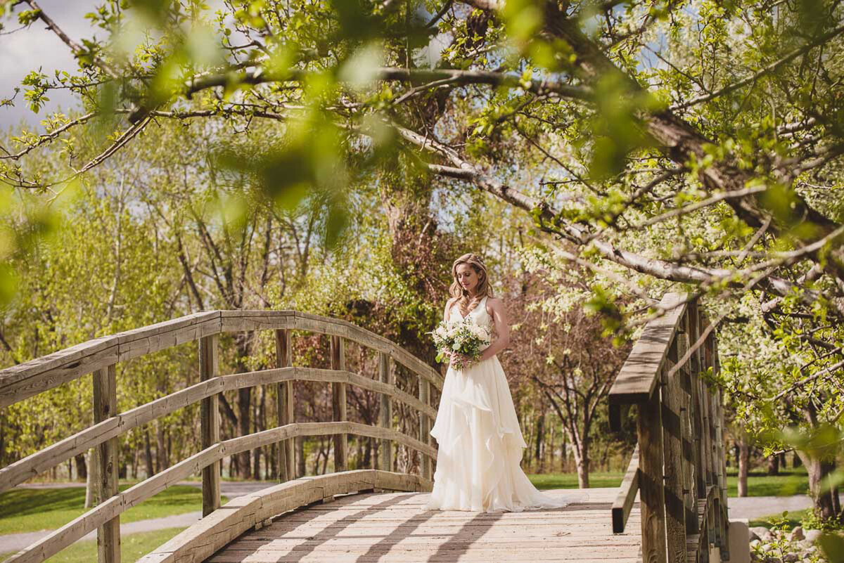 Beautiful bridals on the bridge at River Cafe, a riverside wedding venue in downtown Calgary, featured on the Brontë Bride Vendor Guide.